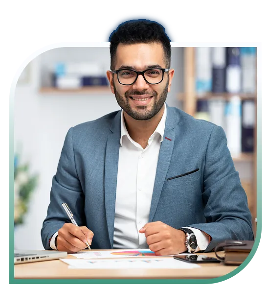 A finance professional smiling while working at a desk